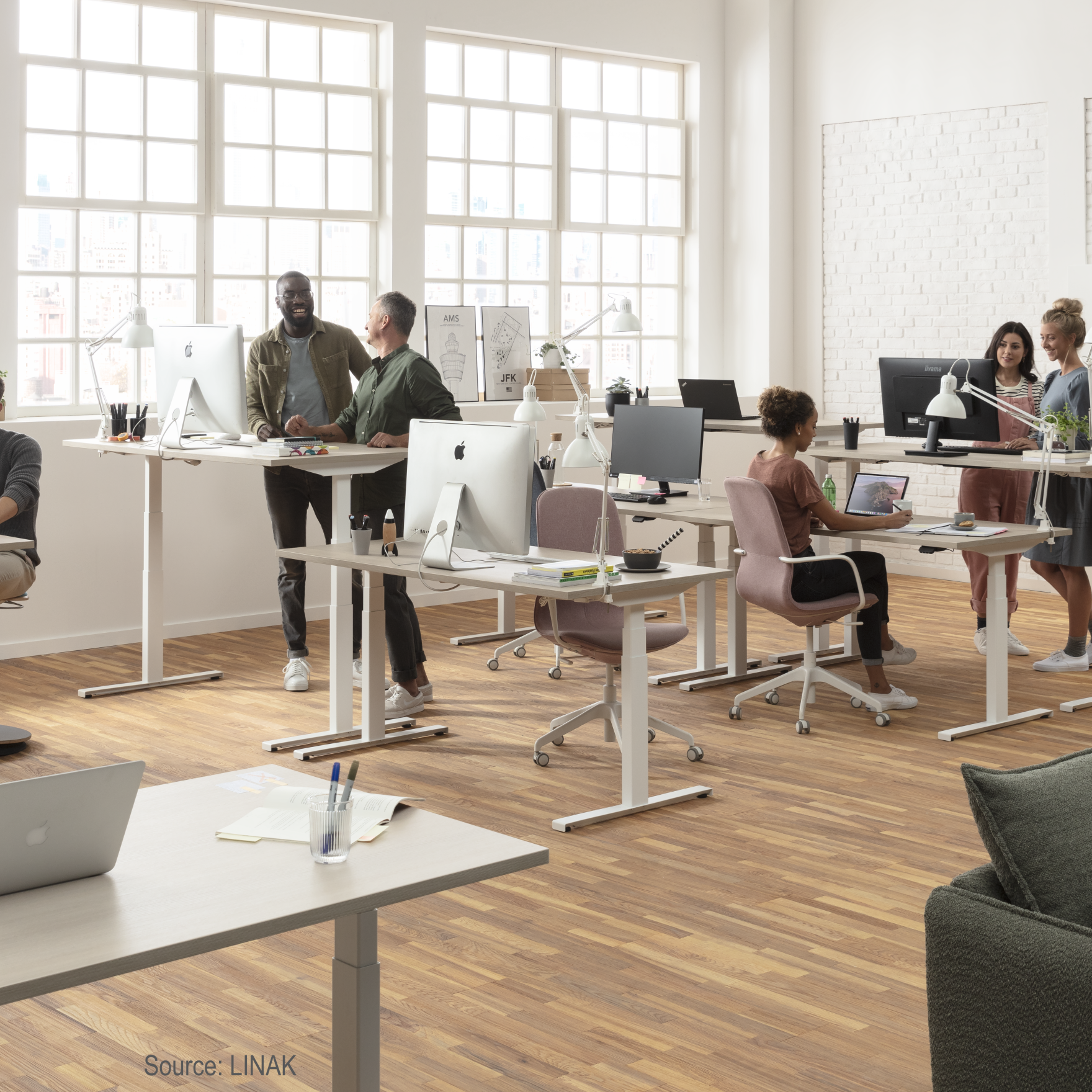 Modern office with sit-stand desks powered by LINAK actuator technology